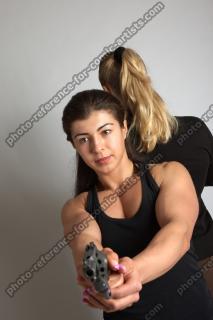 OXANA AND XENIA STANDING POSE WITH GUNS 3